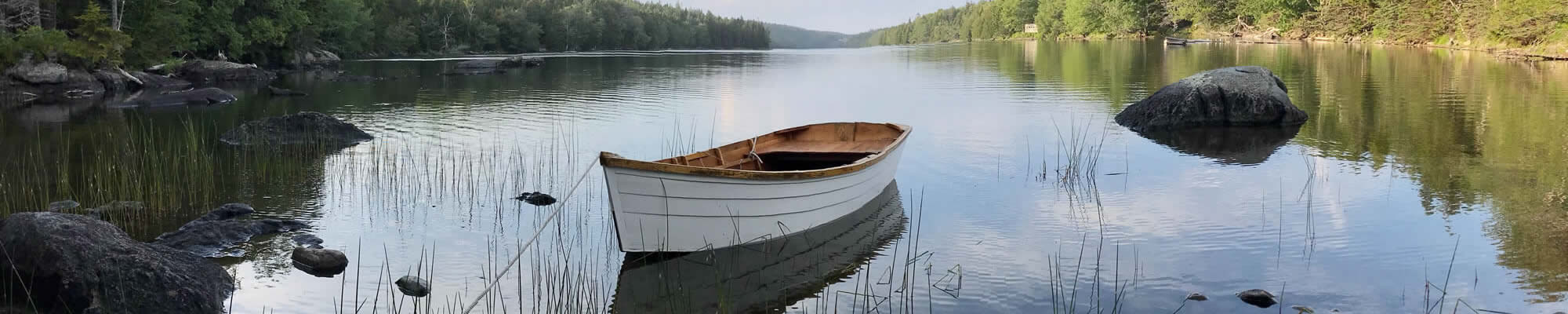 Image of boat tied to dock in a lake.