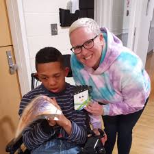 Child in wheelchair with support staff